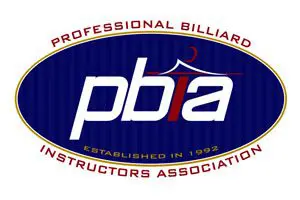 Logo of the Professional Billiard Instructors Association, featuring "pbia" in the center and text "Established in 1992" in a blue oval with a decorative outline.