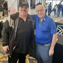 Two men standing next to each other in a room.
