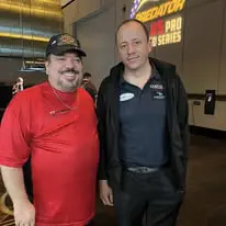 Two men standing next to each other in a room.